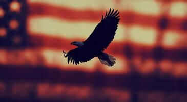 Majestic bald eagle soaring against a blurred American flag backdrop in a patriotic display photo