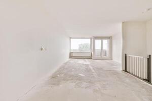 Empty white room with a staircase and a window photo