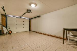 An empty garage with a table and a chair photo