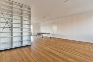 A room with a bookcase and a table photo