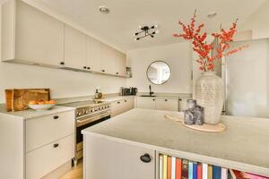 A kitchen with a vase on the counter photo