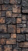 Textured dark brick wall with rusty highlights showing age and character in an urban setting photo