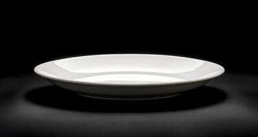 Simple white ceramic plate on a dark background showcasing elegant design and form photo