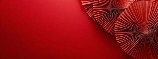 Colorful decorative paper fans arranged on a vibrant red background for a festive occasion photo