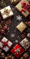 Wrapped Christmas gifts arranged on a festive black background with ornaments photo