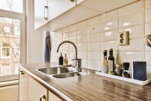 A kitchen with a sink and counter top photo