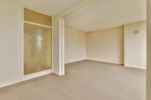 An empty room with a door and a window photo