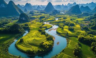 Stunning aerial view of winding river through lush green rice terraces in Guangxi province photo