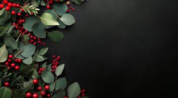 Colorful holiday foliage with red berries and green leaves on a dark background photo