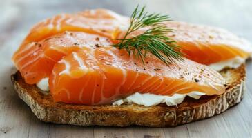 Fresh salmon on toasted bread topped with dill and cream cheese garnished elegantly photo