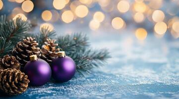 Purple ornaments and pinecones on a snowy surface with a blurred festive background photo