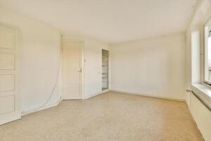 An empty room with a window and a door photo