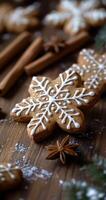 Homemade snowflake-shaped cookies decorated with icing on a wooden surface with spices photo