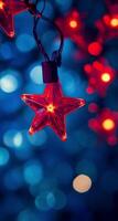 Bright red star ornament glows against a blue and bokeh background during festive season photo