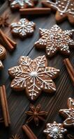 Gingerbread snowflake cookies and cinnamon sticks on a wooden table for winter fun photo