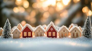 Winter village with snow-covered houses and evergreen trees during sunset photo