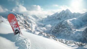 A snowboarder in a red jacket gazes at snowy mountain peaks during a bright winter day photo