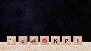 KPI text in wooden cube, Key Performance Indicator concept, Management data System KPI connected database follow earnings, Financial business data analytics graph dashboard. photo