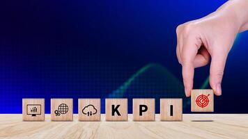 KPI text in wooden cube, Key Performance Indicator concept, Management data System KPI connected database follow earnings, Financial business data analytics graph dashboard. photo