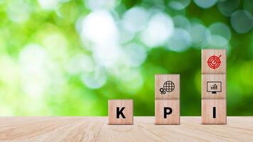 KPI text in wooden cube, Key Performance Indicator concept, Management data System KPI connected database follow earnings, Financial business data analytics graph dashboard. photo