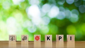 KPI text in wooden cube, Key Performance Indicator concept, Management data System KPI connected database follow earnings, Financial business data analytics graph dashboard. photo