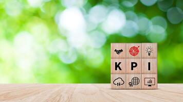 KPI text in wooden cube, Key Performance Indicator concept, Management data System KPI connected database follow earnings, Financial business data analytics graph dashboard. photo