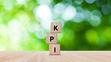 KPI text in wooden cube, Key Performance Indicator concept, Management data System KPI connected database follow earnings, Financial business data analytics graph dashboard. photo