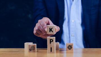 KPI text in wooden cube, Key Performance Indicator concept, Management data System KPI connected database follow earnings, Financial business data analytics graph dashboard. photo
