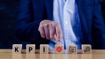 KPI text in wooden cube, Key Performance Indicator concept, Management data System KPI connected database follow earnings, Financial business data analytics graph dashboard. photo