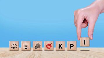 KPI text in wooden cube, Key Performance Indicator concept, Management data System KPI connected database follow earnings, Financial business data analytics graph dashboard. photo