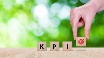 KPI text in wooden cube, Key Performance Indicator concept, Management data System KPI connected database follow earnings, Financial business data analytics graph dashboard. photo