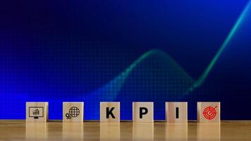 KPI text in wooden cube, Key Performance Indicator concept, Management data System KPI connected database follow earnings, Financial business data analytics graph dashboard. photo