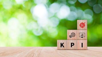 KPI text in wooden cube, Key Performance Indicator concept, Management data System KPI connected database follow earnings, Financial business data analytics graph dashboard. photo