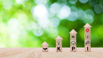 KPI text in wooden cube, Key Performance Indicator concept, Management data System KPI connected database follow earnings, Financial business data analytics graph dashboard. photo