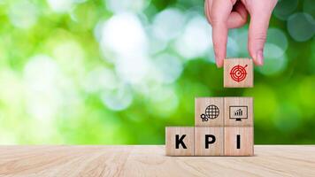 KPI text in wooden cube, Key Performance Indicator concept, Management data System KPI connected database follow earnings, Financial business data analytics graph dashboard. photo