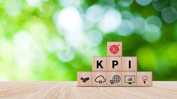 KPI text in wooden cube, Key Performance Indicator concept, Management data System KPI connected database follow earnings, Financial business data analytics graph dashboard. photo