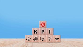 KPI text in wooden cube, Key Performance Indicator concept, Management data System KPI connected database follow earnings, Financial business data analytics graph dashboard. photo