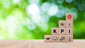 KPI text in wooden cube, Key Performance Indicator concept, Management data System KPI connected database follow earnings, Financial business data analytics graph dashboard. photo