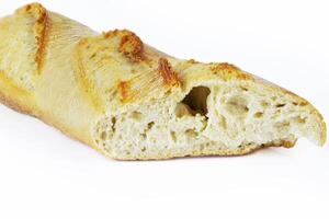 Closeup of a sliced French baguette with a crispy crust and airy texture isolated on a white background. With clipping path. Copy space photo