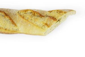 Closeup of a sliced French baguette with a crispy crust and airy texture isolated on a white background. With clipping path. Copy space photo