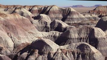 Petrified Forest National Park, Erosion of ancient multi-colored sedimentary rocks from which fossilized sequoias are washed away video