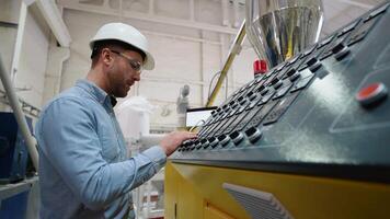Manufacturing worker programming industrial CNC machine tool at pvc factory video