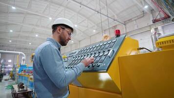 Manufacturing worker programming industrial CNC machine tool at pvc factory video