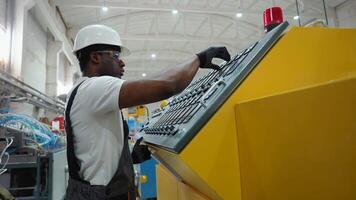 Manufacturing african worker programming industrial CNC machine tool at pvc factory video