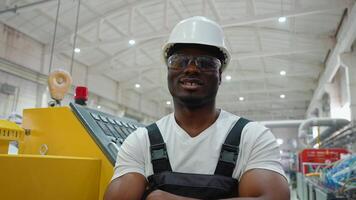 Portrait of african american worker near CNC machine in factory industries video