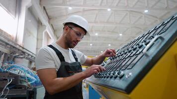 Worker On Factory Analyzes The Production Process And Programming Industrial CNC Machine Tool video