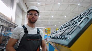 Portrait of engineer operator near CNC machine in factory industries video