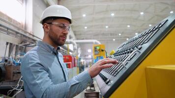 Engineer working at programmable CNC machine in factory industries video