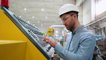 Engineer entering data in CNC machine at pvc window factory to get the production going video