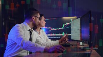 Side view of traders brokers in formalwear analyzing stock market data while working in the office video